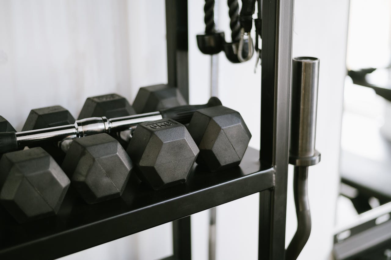 about-01 Close-up of gym equipment including dumbbells on a storage rack, perfect for fitness-themed uses.